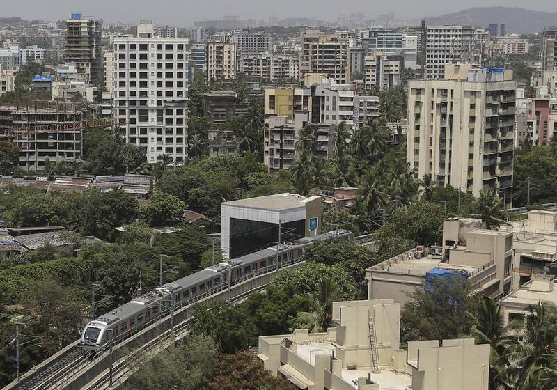 A metro train rides through Mumbai on its opening day. Divyakant Solanki / EPA