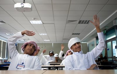 Right to left, Khalifa al Naqbi, 17, and Yusuf al Kendi, react to a question in 'Technology Business Incubation' lecture on Monday, July 11, 2011, the second day of a three-week-long summer camp for the Emirati youth at the Glenelg Primary School in Abu Dhabi. The program, run by the American University of Sharja in association with ATIC, aims to raise interest among the young Emiratis in the semiconductor microelectronics technology and the industry, and thus invest in the UAE's future, post-oil economy.  (Silvia Razgova/The National)


