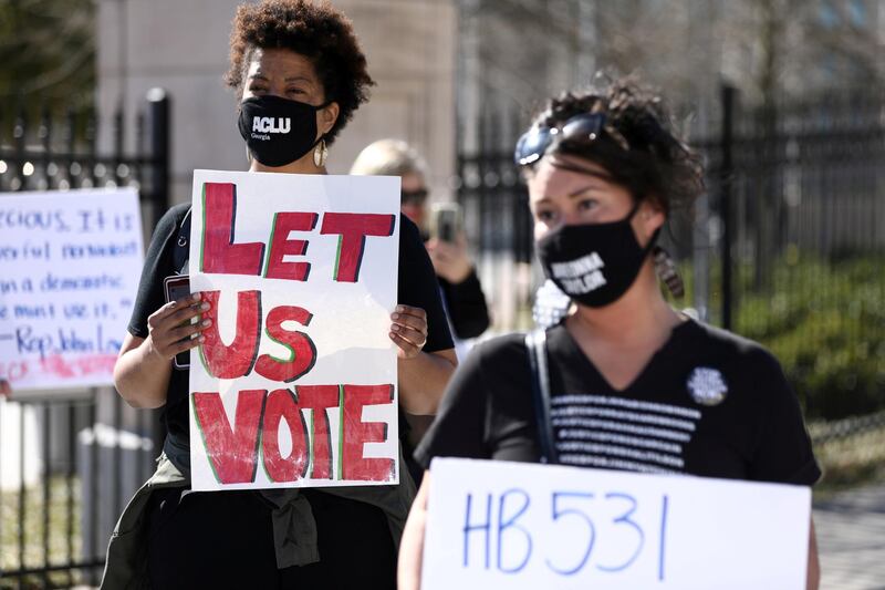 FILE PHOTO: Protesters gather outside of the Georgia State Capitol to protest HB 531, which would place tougher restrictions on voting in Georgia, in Atlanta, Georgia, U.S. March 4, 2021. REUTERS/Dustin Chambers/File Photo