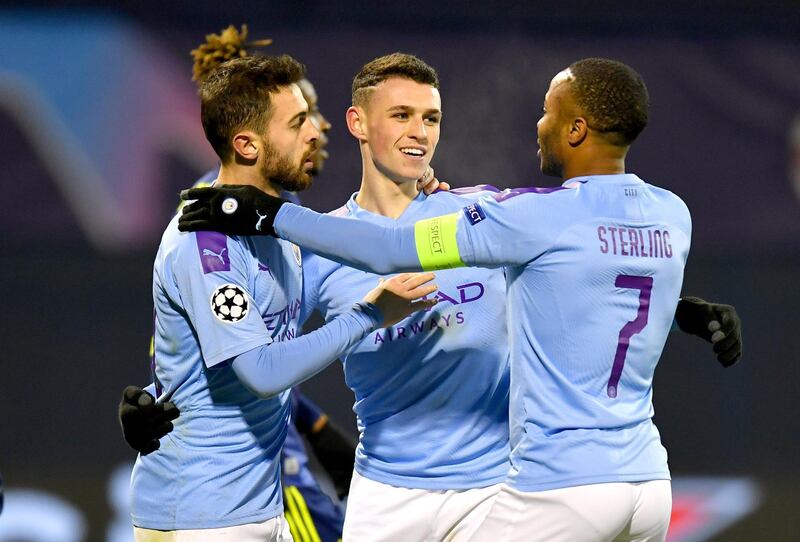 Phil Foden of Manchester City celebrates after scoring his team's fourth goal with Bernardo Silva and Raheem Sterling. Getty