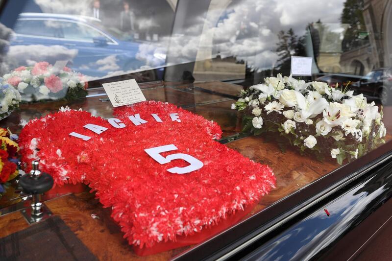 Floral tributes and messages of condolence are pictured as the funeral cortege of British football legend Jack Charlton arrives at the West Road Crematorium. AFP