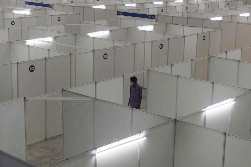 A health worker walks inside the Chennai trade centre, which is being converted into an isolation ward.  AFP