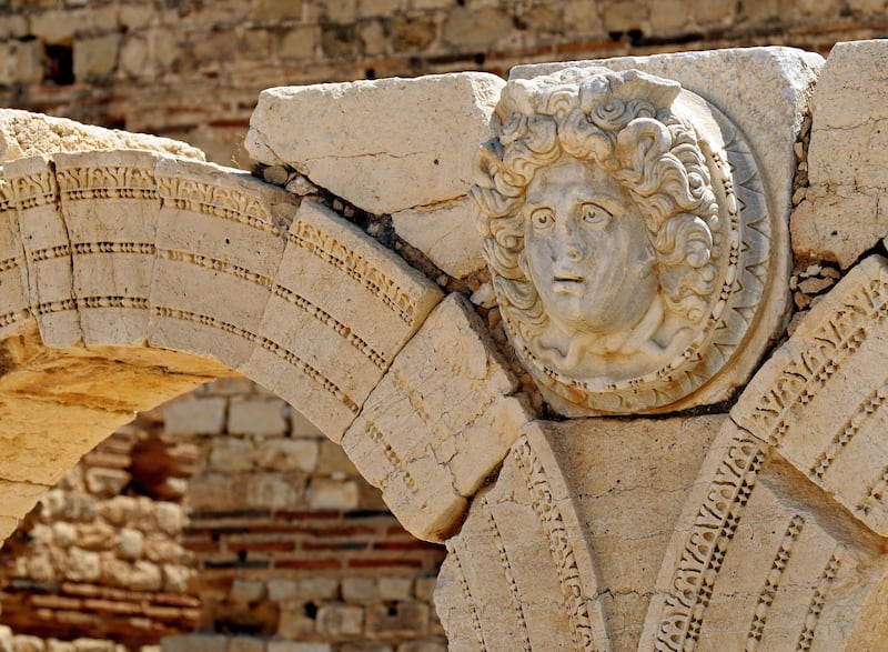 A carved Gorgon head on arches surrounds the Severin forum.