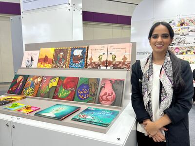 Emirati author Dubai Abulhoul besides her series of Arabic children's books inspired by Emirati folktales. Photo: Saeed Saeed / The National