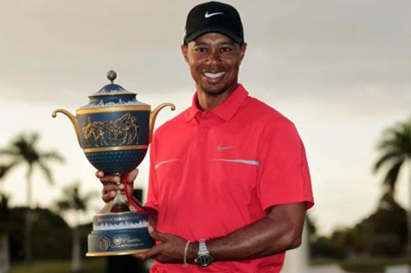 Tiger Woods poses with the Gene Sarazen Trophy after his victory in the 2013 WGC-Cadillac Championship.