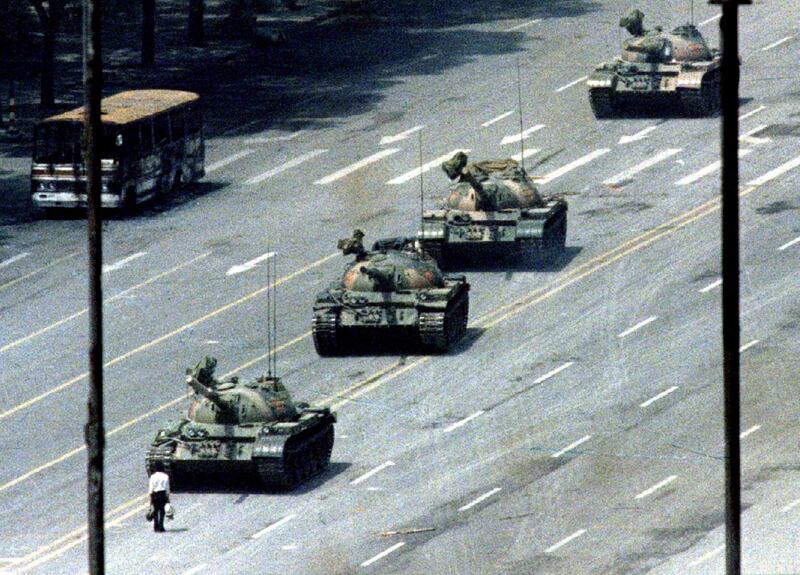 FILE PHOTO 5JUN89 - A Peking citizen stands passively in front of a convoy of tanks on the Avenue of Eternal peace (Tiananmen Square  REUTERS/Stringer