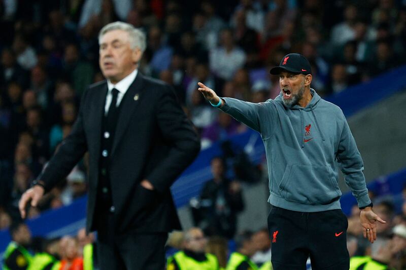 Real Madrid coach Carlo Ancelotti and Liverpool manager Jurgen Klopp on the sidelines. Reuters