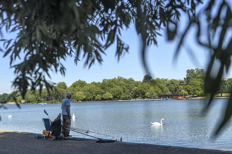 LONDON, ENGLAND  - JUNE 25: A man is seen fishing on the Serpentine in Hyde Park on June 25, 2020 in London, United Kingdom. The UK is experiencing a summer heatwave, with temperatures in many parts of the country expected to rise above 30C and weather warnings in place for thunderstorms at the end of the week. (Photo by Peter Summers/Getty Images)