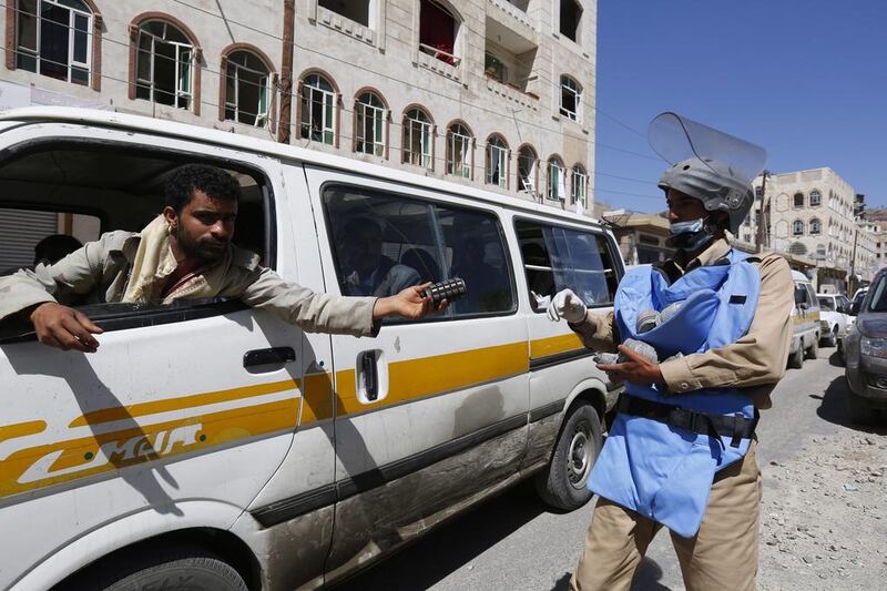 A Yemeni driver hands over an explosive to a deminer at the scene of an airstrike  carried out by the Saudi-led coalition on a nearby Houthi controlled missile depot in Sanaa, on April 22, 2015. Thousands of families returned to Sanaa during a pause in the air campaign by the Saudi-ledcoalition. Yahya Arhab/EPA