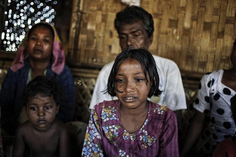 Tawhera Begum, sister of Senwara, cries as she watches a video interview of her sister. After their village was attacked and the family split up, Senwara fled by boat and ended up in Indonesia. Tawhera is with her parents in the Ohn Taw refugee camp on the outskirts of Sittwe, Myanmar. AP Photo/Kaung Htet