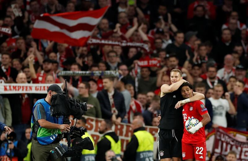 Bayern Munich's Manuel Neuer and Serge Gnabry celebrate after the match. Reuters