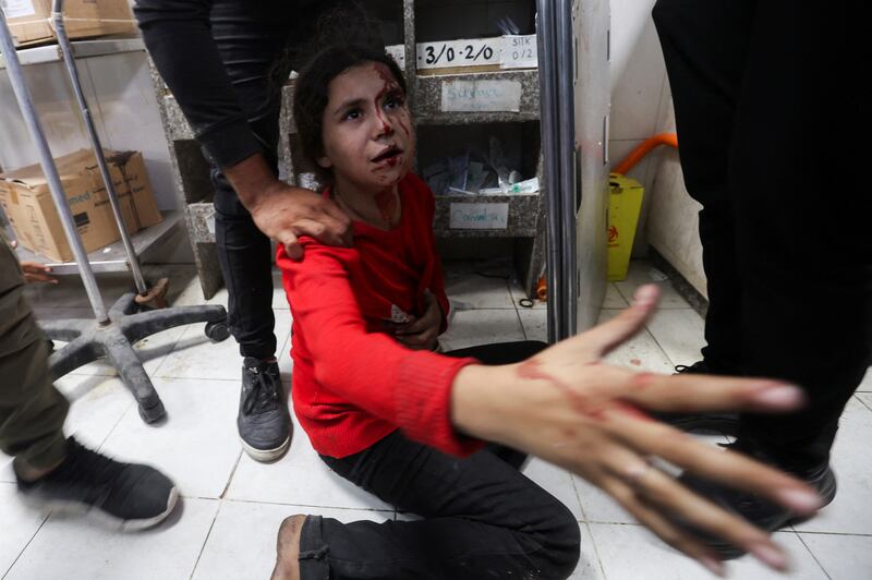 A Palestinian girl sits on the floor of Nasser hospital in Khan Younis after an Israeli strike. Reuters