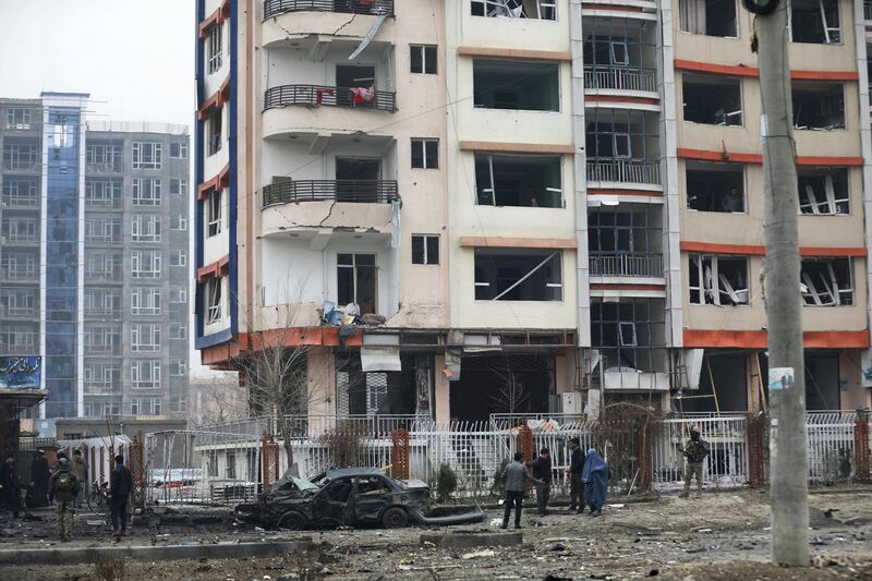 Afghan security personnel inspect the site of a bombing attack in Kabul, Afghanistan, Sunday, Dec. 20, 2020. The strong car bomb explosion rocked the capital Kabul city on Sunday morning, killing multiple people, said a government official. (AP Photo/Rahmat Gul)