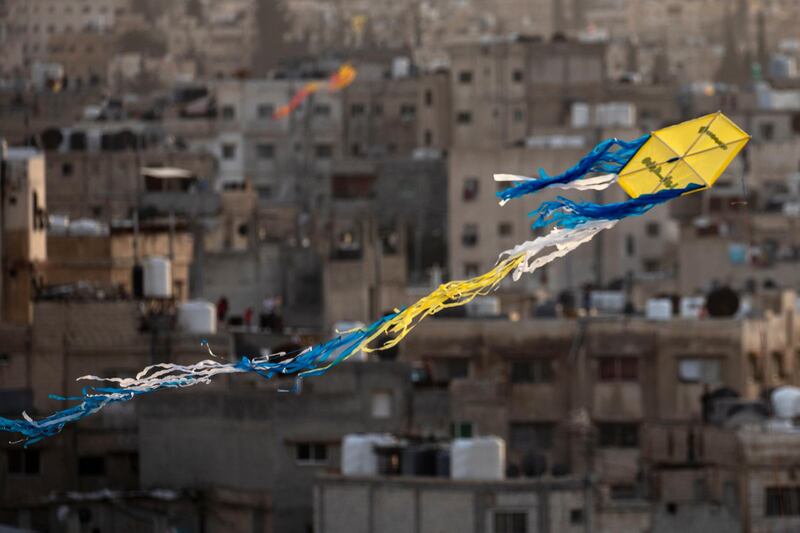 A kite with 'Stay Home' written on it, flies over east Amman, Jordan.  EPA