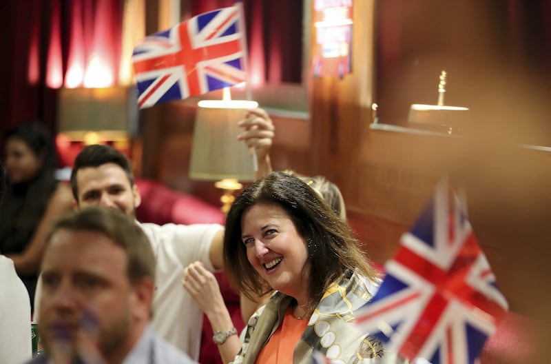DUBAI , UNITED ARAB EMIRATES , MAY 19 – 2018 :- People watching the ceremony of British Royal Wedding at the Golden Lion Pub on the QE2 at Port Rashid in Dubai.  ( Pawan Singh / The National )  For News