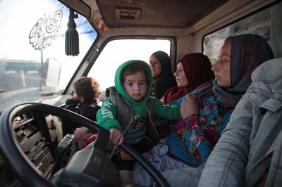 Syrians sit in a vehicle as they drive towards the northern areas of Syria's Idlib province near the Syrian-Turkish border as they flee the bombardments in the southern areas of the country's last major opposition bastion, on December 20, 2019. / AFP / Aaref WATAD
