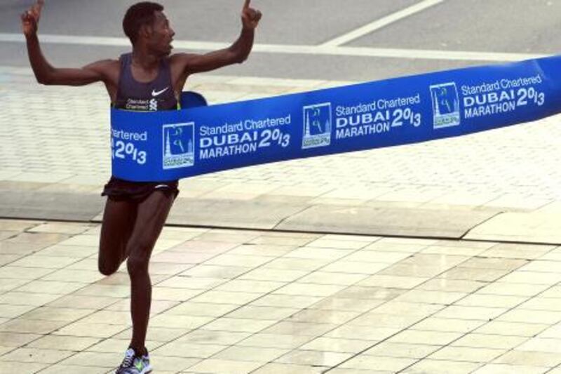 Lelisa Desisa Benti of Ethiopia crosses the finish line to win the Standard Chartered Dubai Marathon in Dubai, United Arab Emirates, Friday Jan. 25, 2013. (AP Photo)