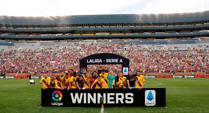 Barcelona's players pose with their trophy after winning the La Liga-Serie A Cup match. AFP