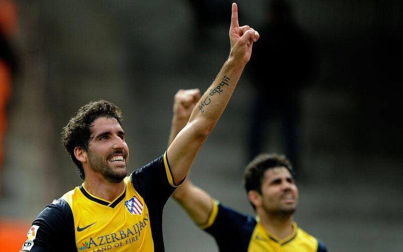 Atletico Madrid midfielder Raul Garcia celebrates his goal against Valencia on Sunday as Diego Costa celebrates with him in the background. Jose Jordan / AFP / April 27, 2014   

