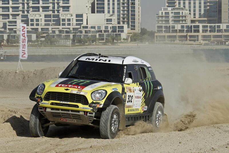 Nani Roma and co-driver Michel Perin plow their Mini All 4 through the sand during Super Stage 5 of the Abu Dhabi Desert Challenge on April 5, 2014. Courtesy Abu Dhabi Desert Challenge
