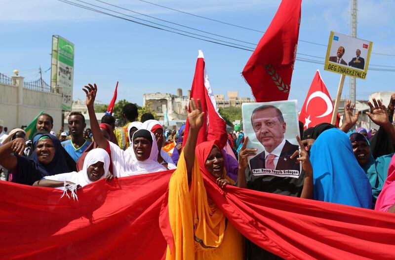 Somalis carry Turkish and Somali flags as they gather in support of Turkish president Recep Tayyip Erdogan and his government in Mogadishu on July 16, 2016. Feisal Omar/Reuters