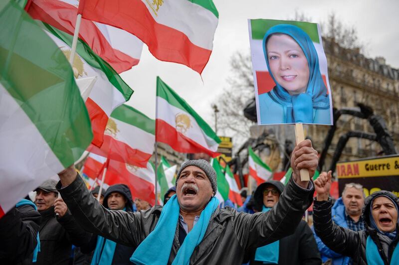 People wave former Iranian flags and a picture of Maryam Rajavi, leader of the People's Mujahedin of Iran, during a demonstration of the exiled Iranian opposition to protest against the celebration in Iran of the 40th anniversary of the Islamic Revolution, on February 8, 2019 in Paris.  / AFP / -
