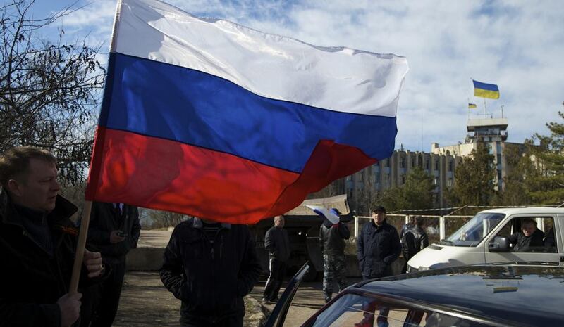 Town residents, some of them pro-Russian supporters, gather outside the Ukrainian naval base headquarters in Novo-Ozerne, Ukraine, on Monday, March 3, 2014. Ivan Sekretarev / AP photo