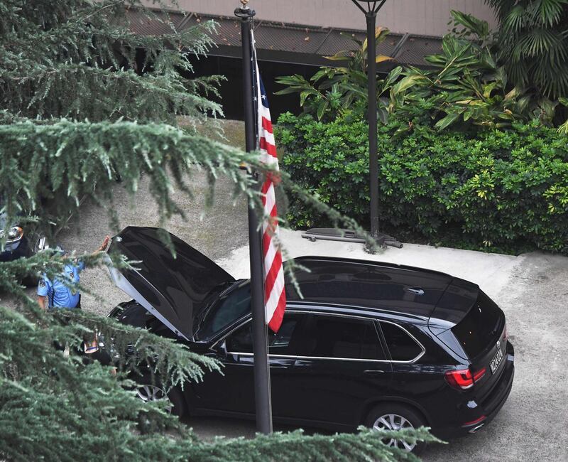 A security guard checks a car inside the US consulate in Chengdu. AFP