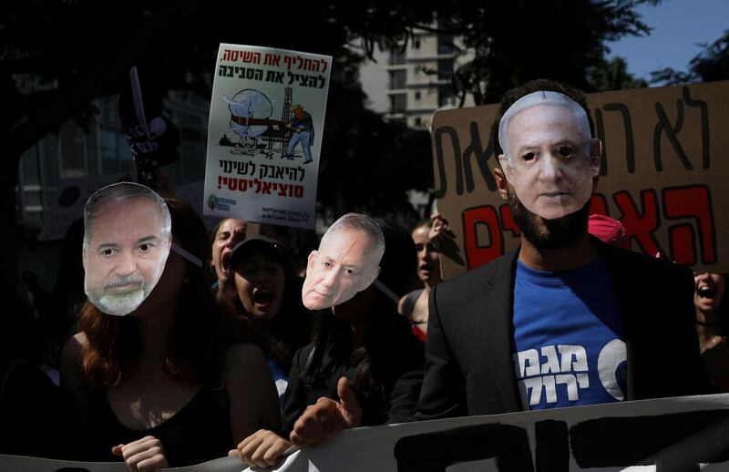 Protesters wear masks of Prime Minister Benjamin Netanyahu, Member of Knesset Beni Gentz and Member of Knesset Avigdor Liberman, as people take part in a protest against climate change during an event in Tel Aviv, Israel September 27, 2019. REUTERS/Ammar Awad