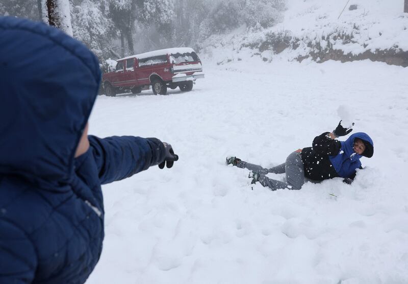 Children in California engage in a snowball fight. AFP