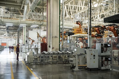 Robotic arms operate on a production line during a media tour of the Nio Inc. production facility in Hefei, Anhui province, China, on Friday, Dec. 4, 2020. Nio is cementing its role as a challenger to Tesla Inc. in China's premium electric-vehicle segment, with both companies benefiting as the coronavirus pandemic recedes in the country. Photographer: Qilai Shen/Bloomberg