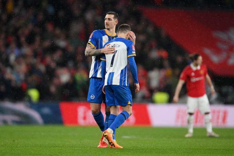 Solly March is consoled by Lewis Dunk of Brighton & Hove Albion after missing in the penalty shootout. Getty 