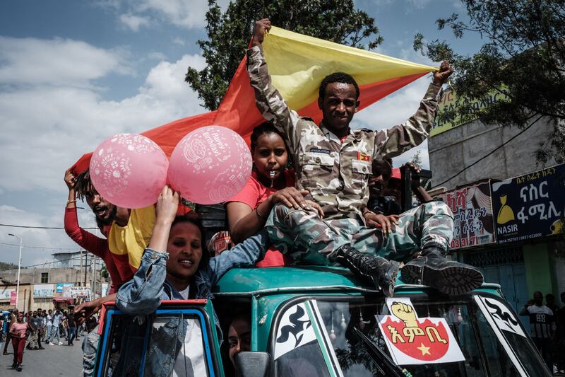 A soldier of Tigray Defence Force (TDF) parades on a motor tricycle as he returns to Mekelle.