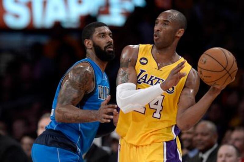 Kobe Bryant looks for a way past Dallas' OJ Mayo.