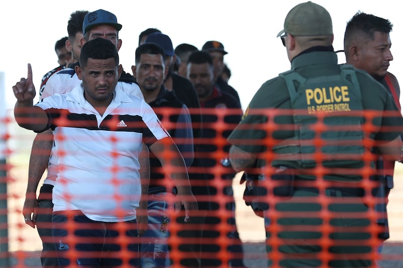 Migrants being processed by US Border Patrol personnel under International Bridge II in Eagle Pass, Texas. AP