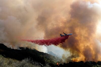 An air tanker drops retardant on a wildfire on October 13, 2021, in Goleta, California. AP