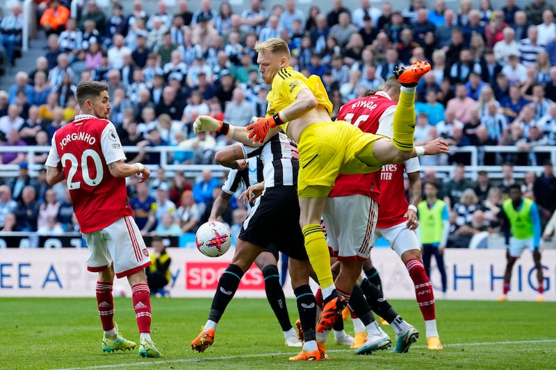 Arsenal goalkeeper Aaron Ramsdale spills the ball under pressure from Newcastle's Bruno Guimaraes. AP 