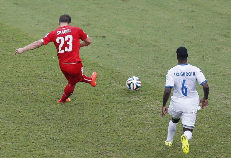Xherdan Shaqiri of Switzerland shoots and scores his team's third goal to complete a hat-trick against Honduras on Wednesday at the 2014 World Cup. Frank Augstein / AP