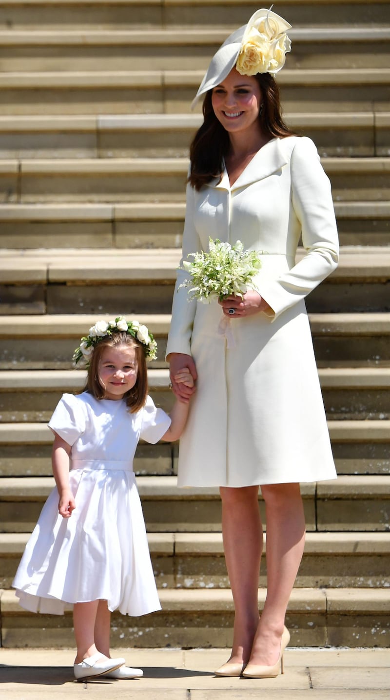 Arriving at the wedding of Prince Harry and Meghan Markle with Princess Charlotte in May. AFP