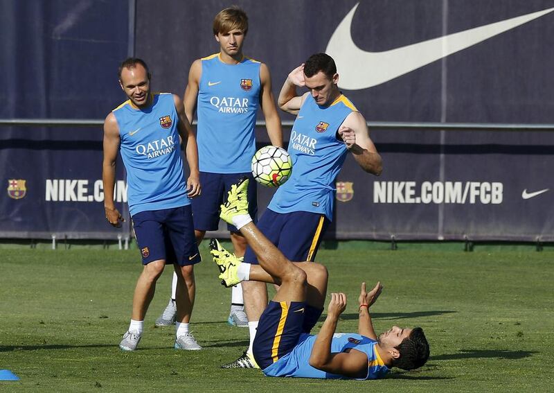 Luis Suarez, bottom, attempts to control the ball while on the ground. Josep Lago / AFP / July 13, 2015