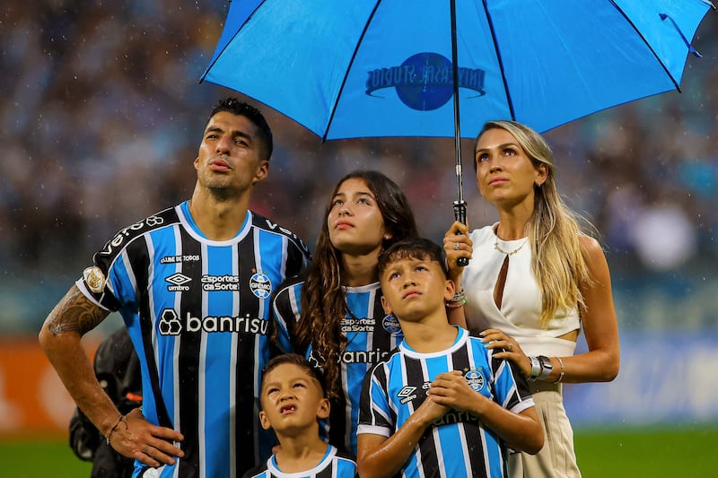 Luis Suarez and his family watch a video in his honour at the end of the match between Gremio and Vasco da Gama. AFP