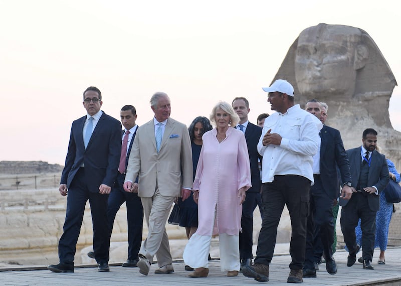 Charles and Camilla pass the Sphinx at the Giza Pyramids plateau.  AFP