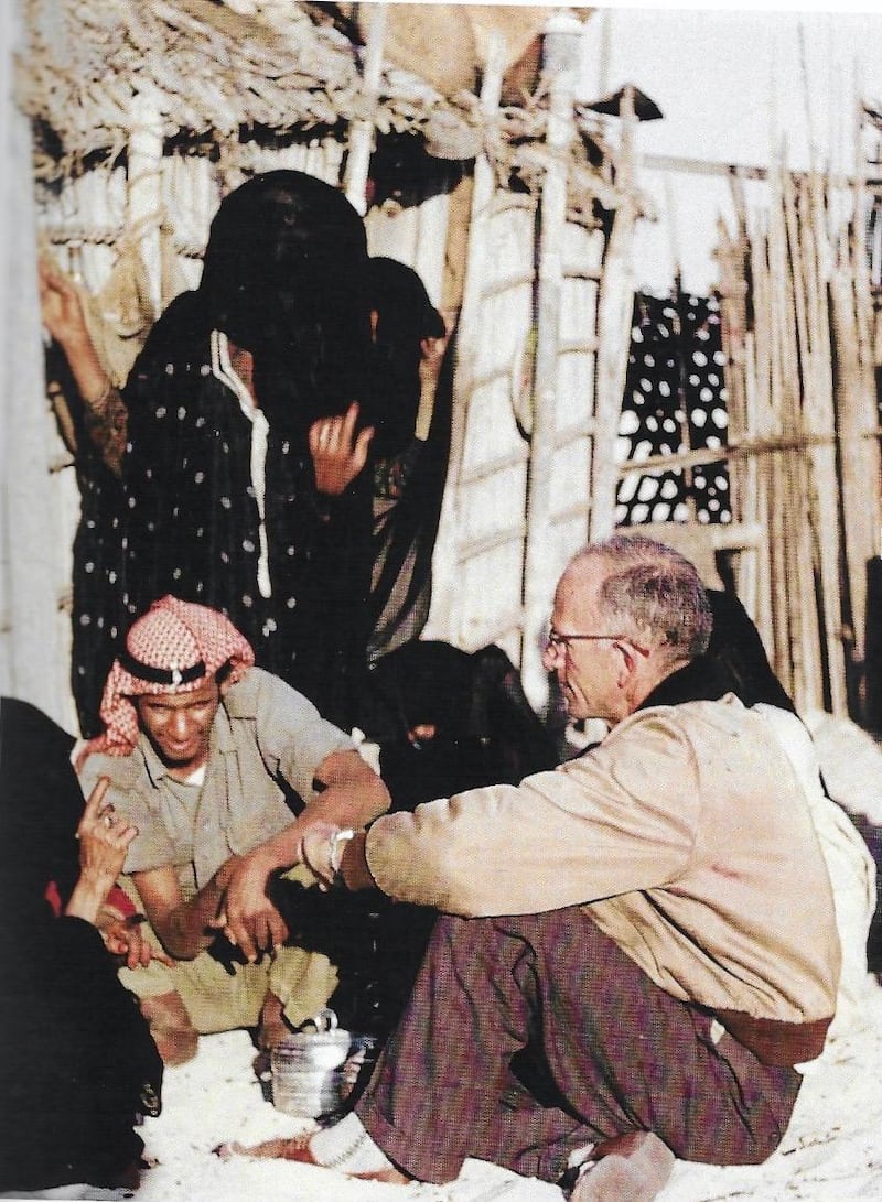Dr Pat Kennedy examines a patient by the barasti hut that was their clinic, with a Trucial Oman Scout as translator. Oasis Hospital, the clinic they founded 60 years ago was renamed Kanad Hospital in their honour last month. Courtesy: UAE National Archives