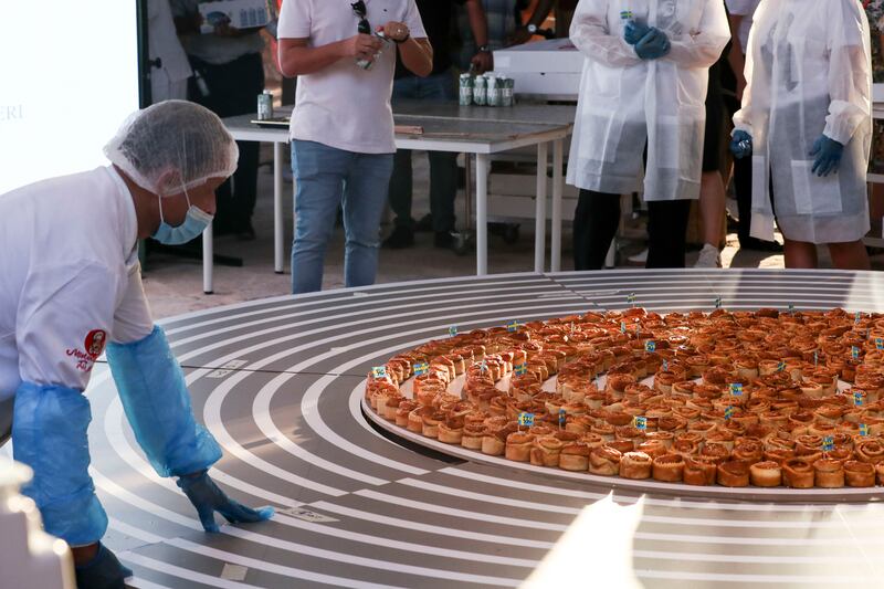 A warm, sweet scent filled the air inside the Swedish pavilion at the world’s fair, as an attempt to create the world’s 'longest cinnamon bun train' got under way.