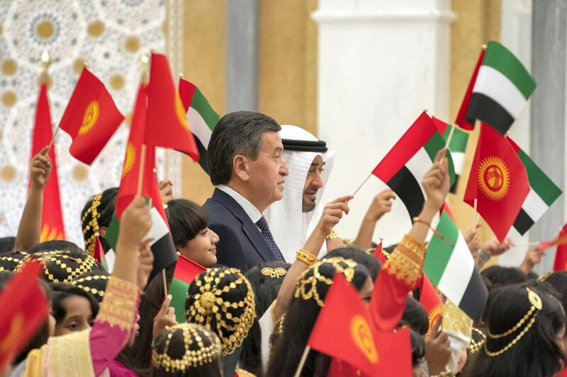 ABU DHABI, UNITED ARAB EMIRATES -December 12, 2019: HH Sheikh Mohamed bin Zayed Al Nahyan, Crown Prince of Abu Dhabi and Deputy Supreme Commander of the UAE Armed Forces (center R) and HE Sooronbay Sharipovich Jeenbekov, President of Kyrgyzstan (center L), stand for a photograph with school children during an official visit reception, at Qasr Al Watan. 

( Rashed Al Mansoori / Ministry of Presidential Affairs )
---