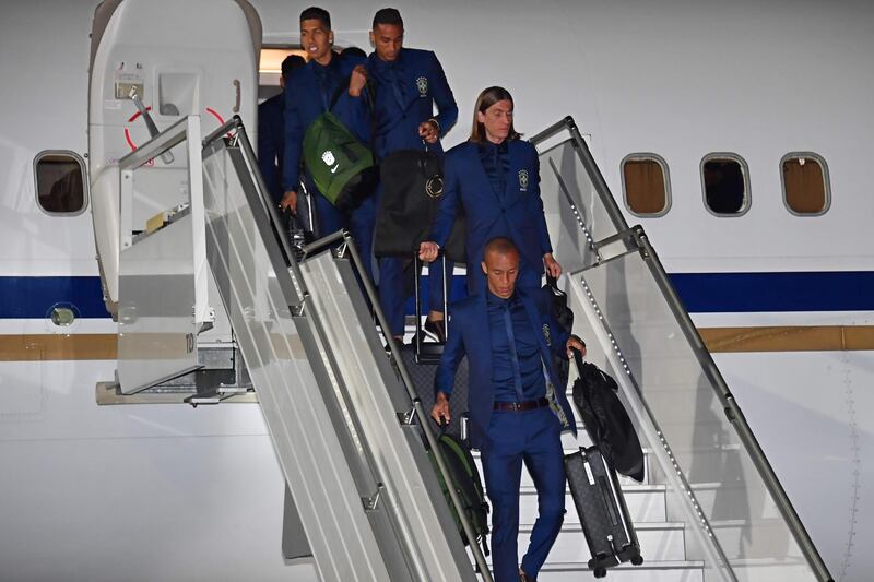 Left to right: Brazil's Firmino, Danilo, Filipe Luis and Miranda descend from the plane upon the team's arrival at Sochi airport in Russia on Monay ahead of the World Cup. Nelson Almeida / AFP