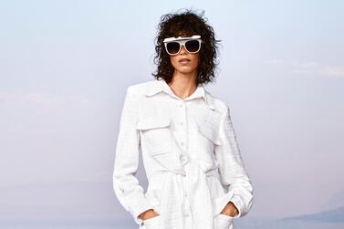 A belted jacket feels elegant over wide legged trousers, especially worn with these ingenious flip-up sunglasses. Chanel Cruise collection 2020/21