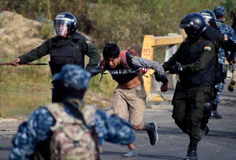 Police detain a supporter of former President Evo Morales during clashes in Sacaba, Bolivia. AP Photo