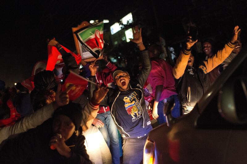 Supporters of President Uhuru Kenyatta celebrate in Kikuyu Town , Kenya, after he was declared the winner of the presidential election, Friday, Aug. 11, 2017. Kenya's election commission announced Friday that President Uhuru Kenyatta has won a second term as opposition candidate Raila Odinga claimed the vote was rigged. (AP Photo/Jerome Delay)