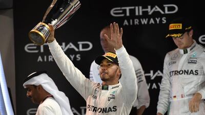 Lewis Hamilton salutes the crowd after winning the 2016 Abu Dhabi Grand Prix, although his victory was not enough for him to retain his drivers' championship title. Mohammad Al Shaikh / AFP